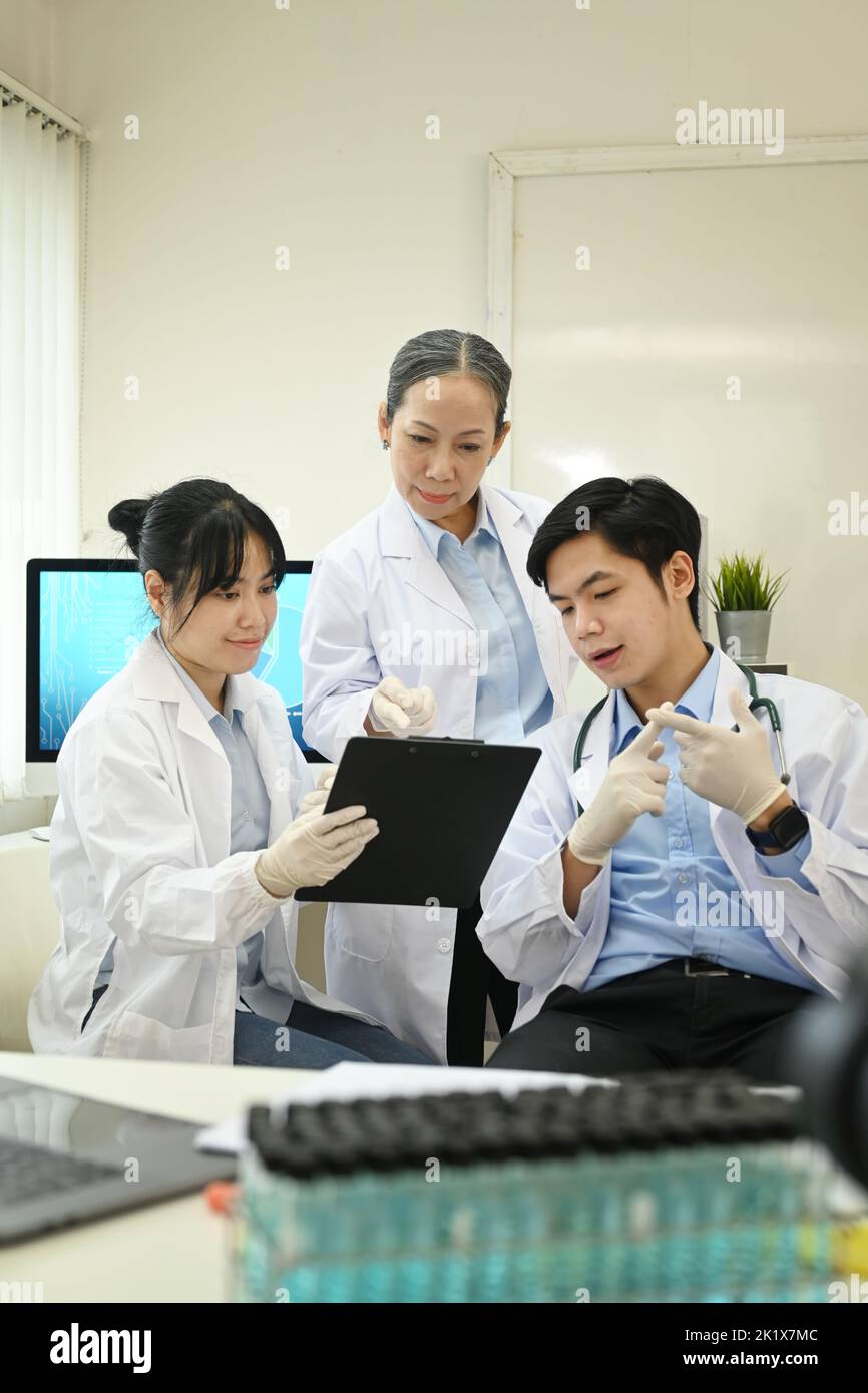 Professional scientists wearing white coats conducting experiment in