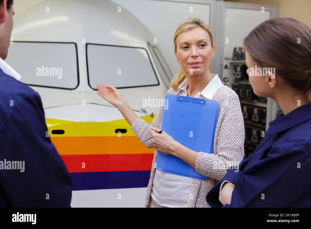 woman showing a plane to apprentice Stock Photo - Alamy