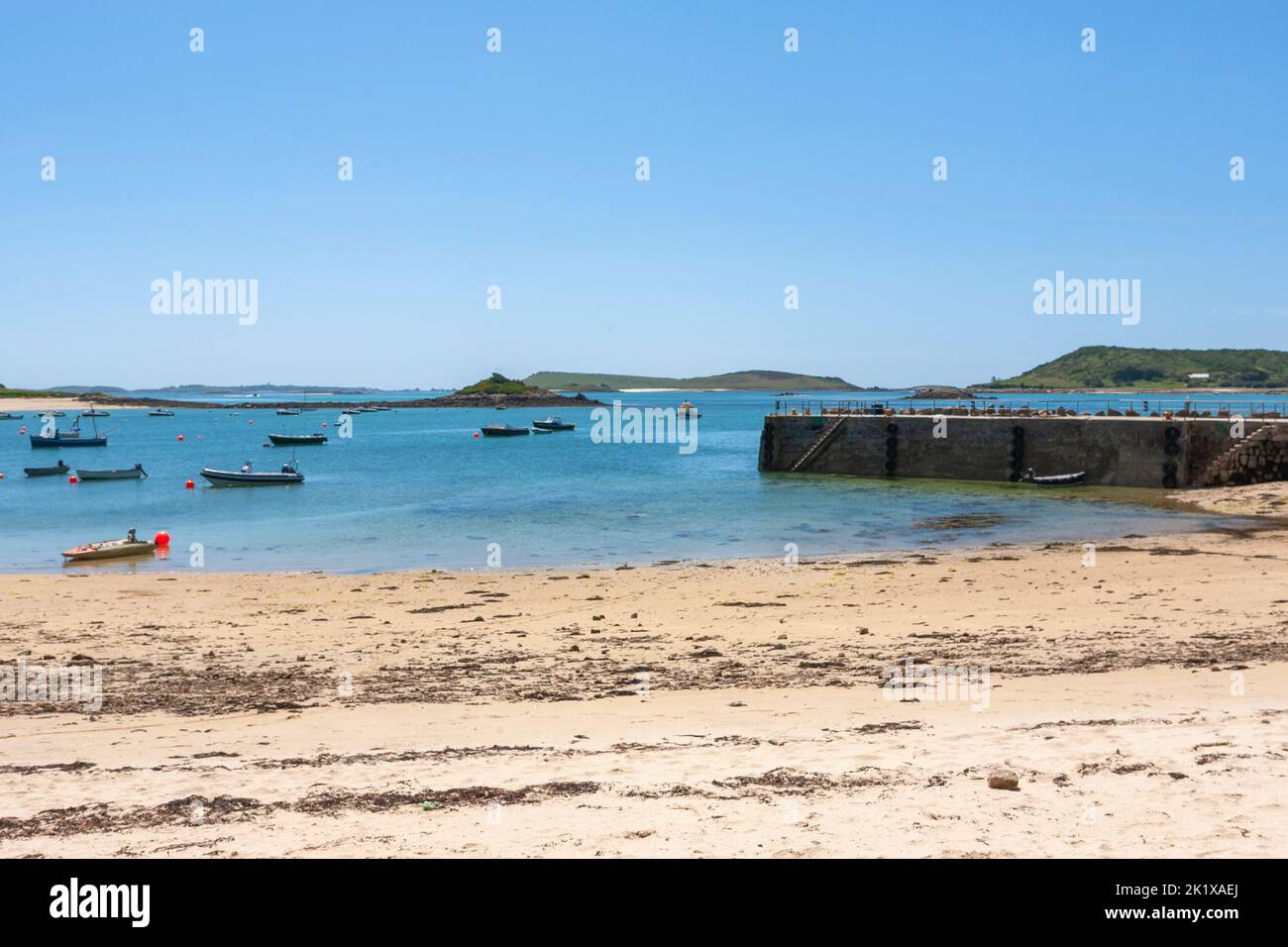 Looking across Tresco Flats from the quay at New Grimsby, Tresco, towards Bryher and Samson, with St. Mary's in the far distance: Isles of Scilly, UK Stock Photo