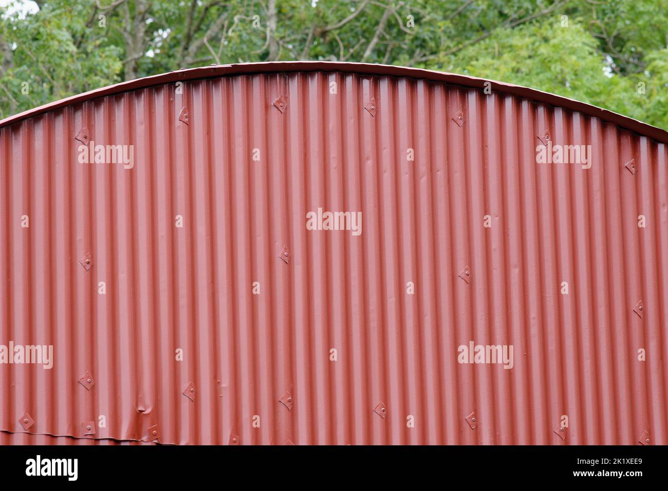 A maroon painted surface of an agricultural barn. Suitable as a background or as an element. Stock Photo
