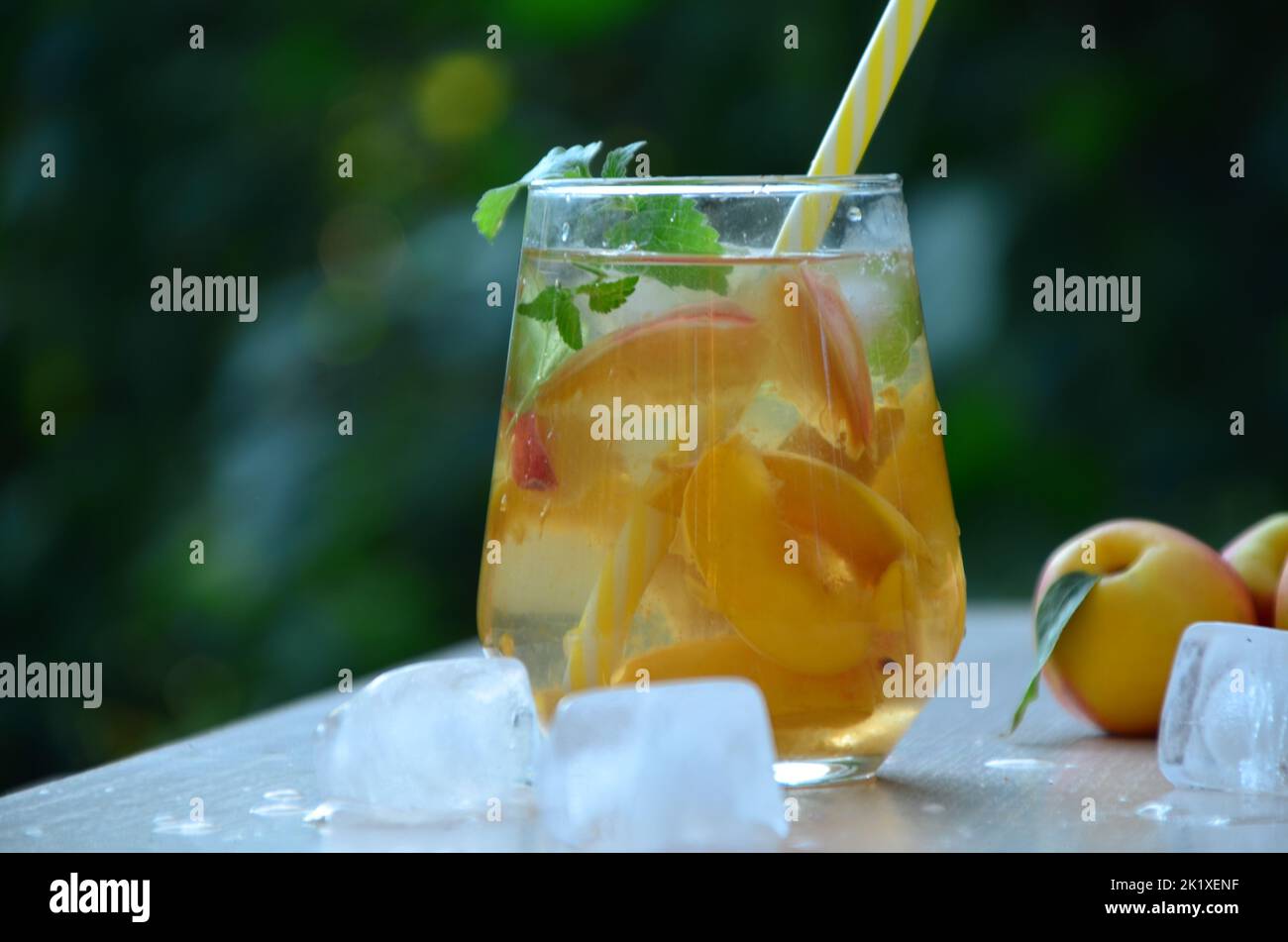 Summer drinks, with mint and peach cocktails with ice in glasses