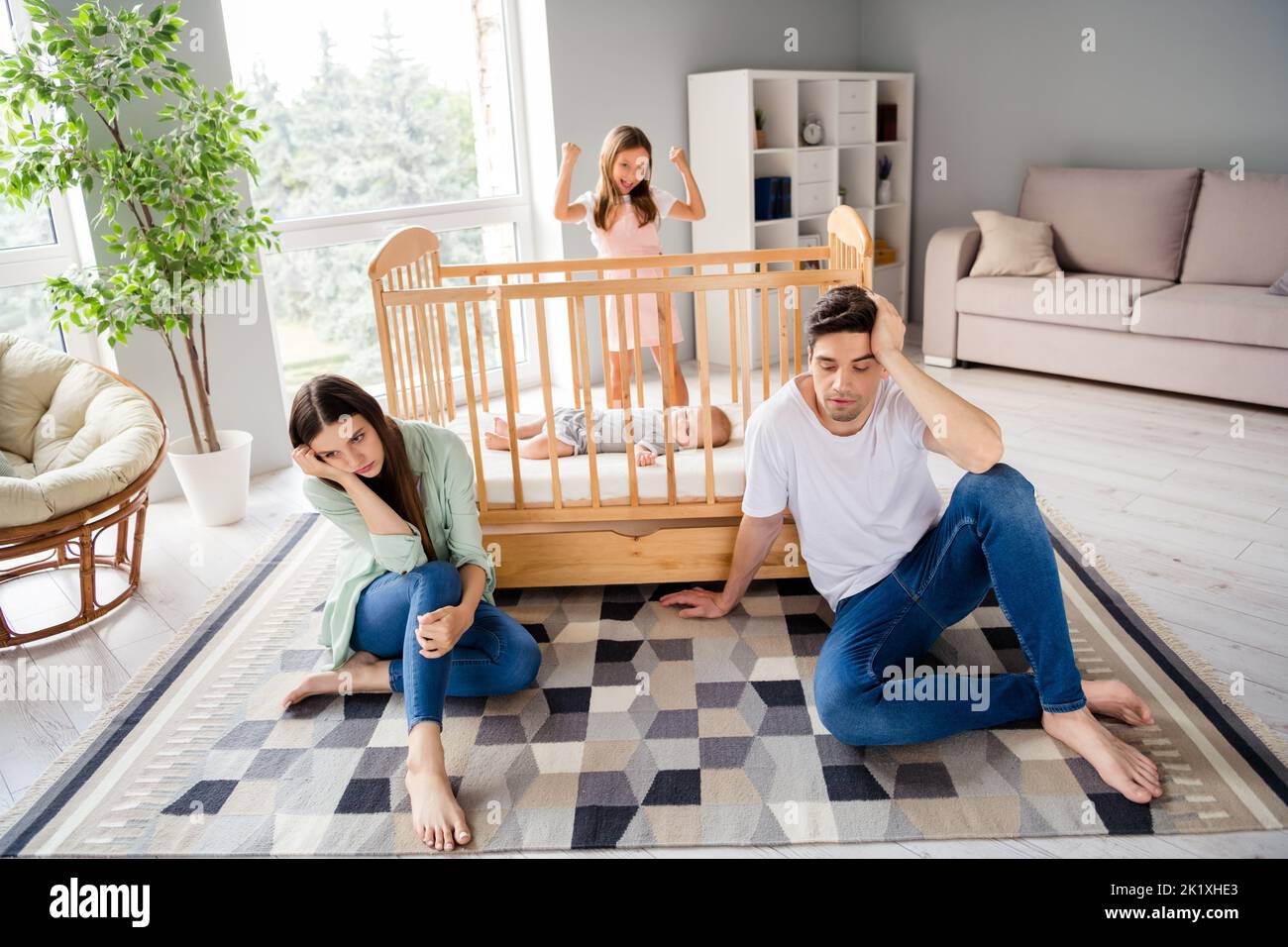 Full size portrait of full family tired parents sit carpet floor