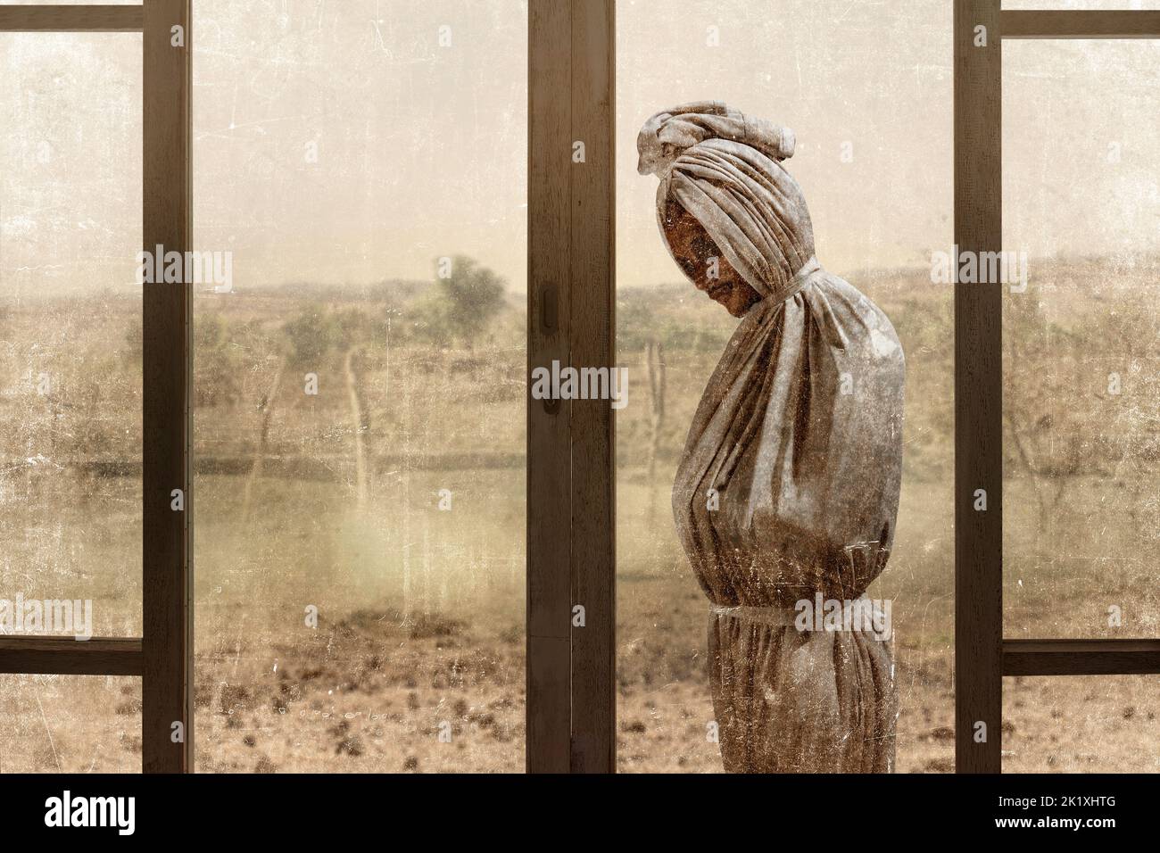 Pocong is covered with a white linen shroud standing outside an abandoned house. Halloween concept Stock Photo