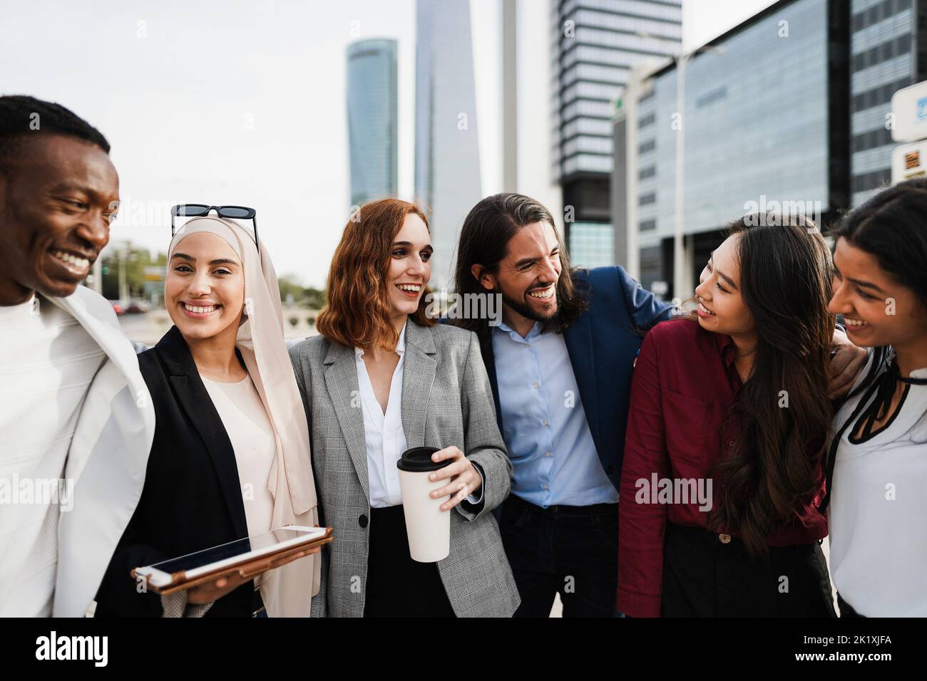 Multiracial business people working outdoor from office building - Focus on asian girl face Stock Photo