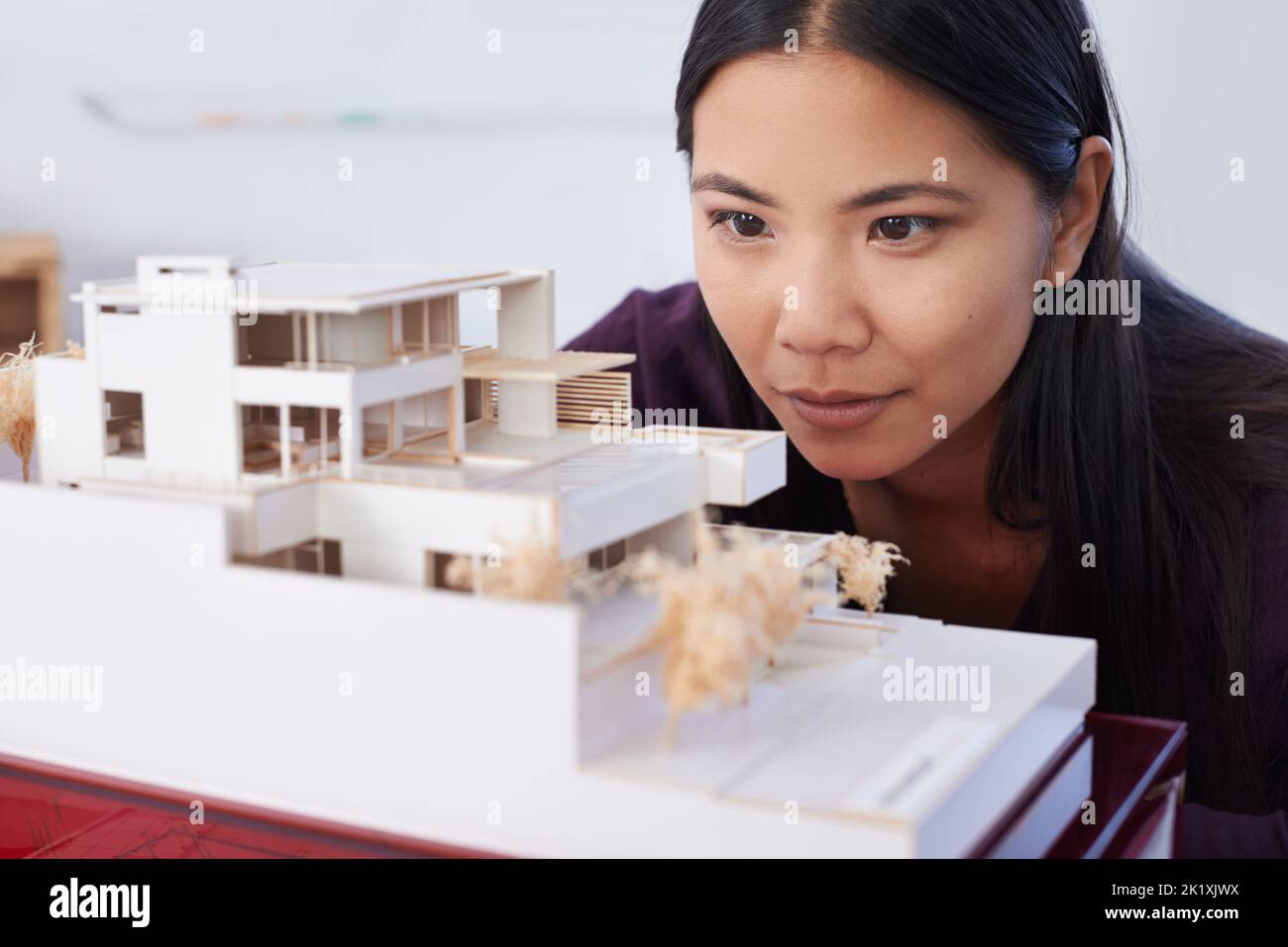 The product of patience and a lot of glue. Close-up of a young student viewing a scale model. Stock Photo