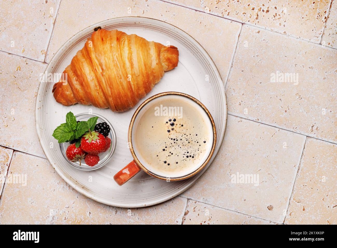 Coffee cup, berries and croissant. Flat lay with copy space Stock Photo