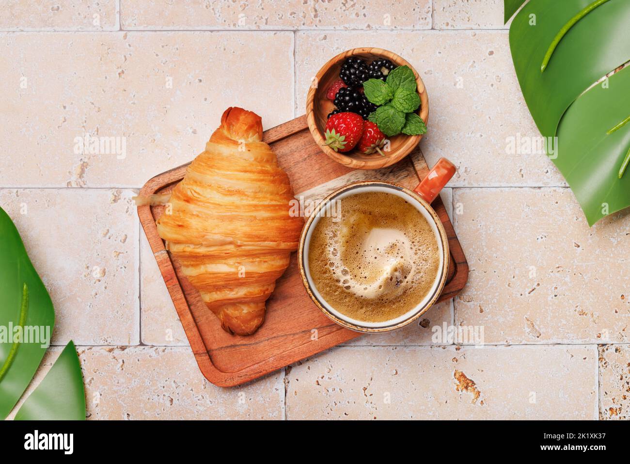 Coffee cup, berries and croissant. Flat lay Stock Photo