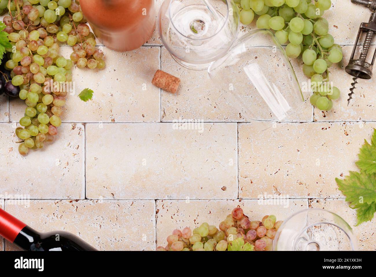 White, rose and red wine bottles, grapes and glasses. Flat lay with copy space Stock Photo