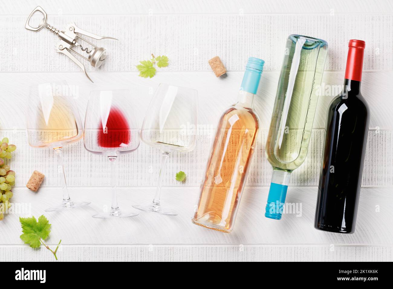 White, rose and red wine bottles and glasses. Flat lay Stock Photo