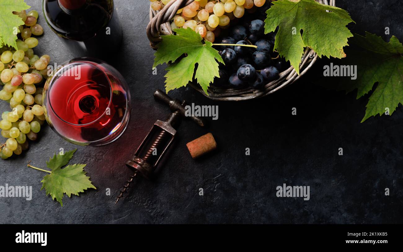 Red wine glass and grape in basket. Flat lay with copy space Stock Photo