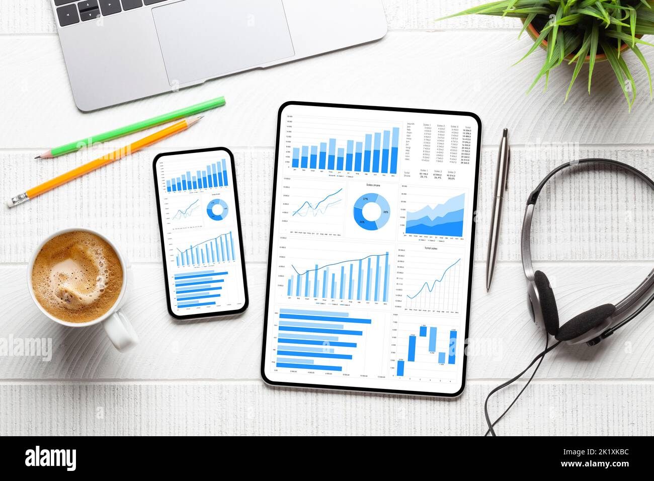 Tablet and smartphone with business reports and charts. Top view flat lay with copy space Stock Photo