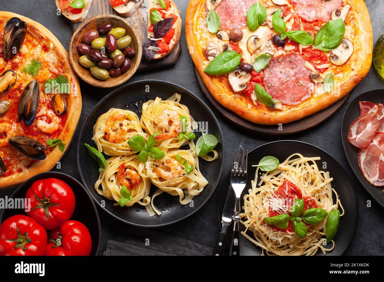 Italian cuisine. Pasta, pizza, olives and antipasto toasts. Flat lay Stock Photo