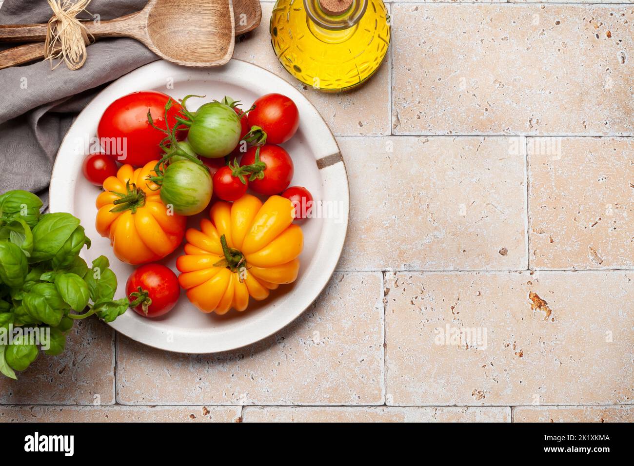 Various colorful garden tomatoes. Fresh vegetables and spices. Top view flat lay with copy space Stock Photo