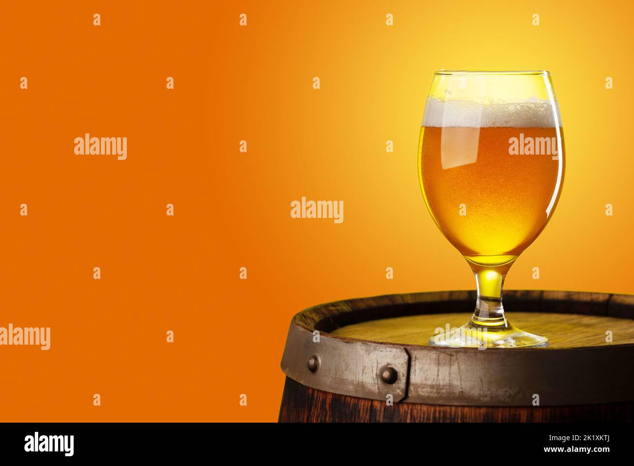 Beer glass on wooden barrel. With copy space Stock Photo