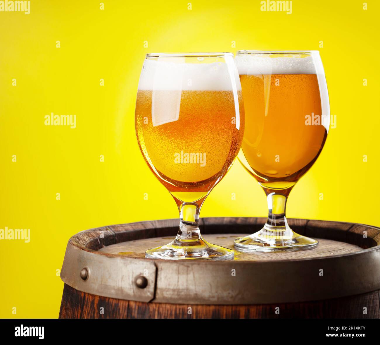 Two beer glasses on wooden barrel. With copy space Stock Photo