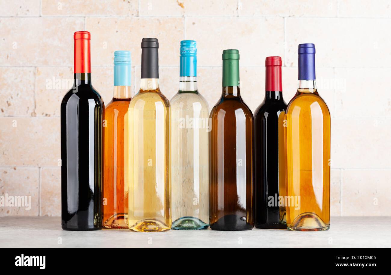 Various wine bottles on stone table Stock Photo