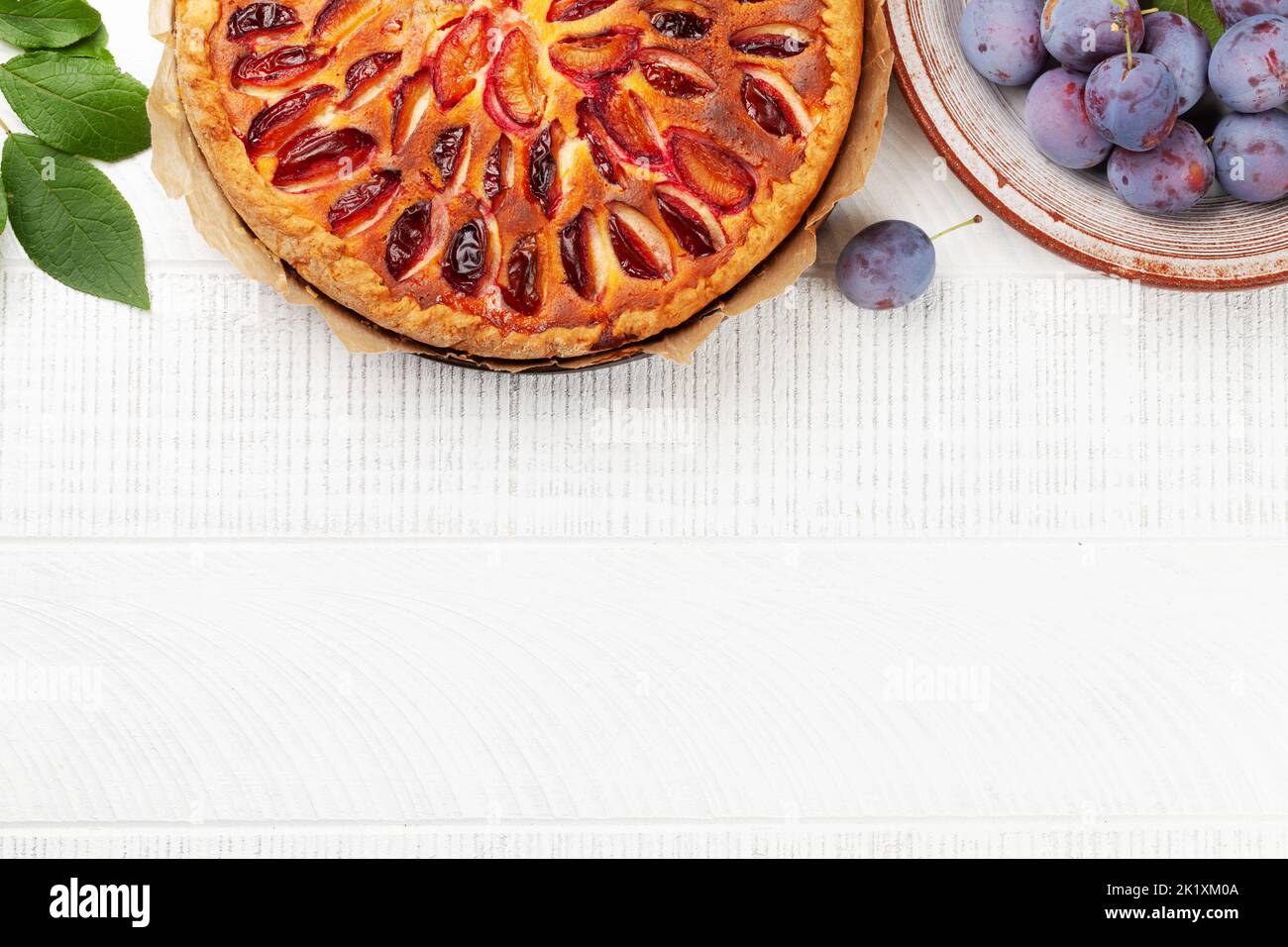 Homemade plum pie. Fruit tart with seasonal fruits. Flat lay with copy space Stock Photo