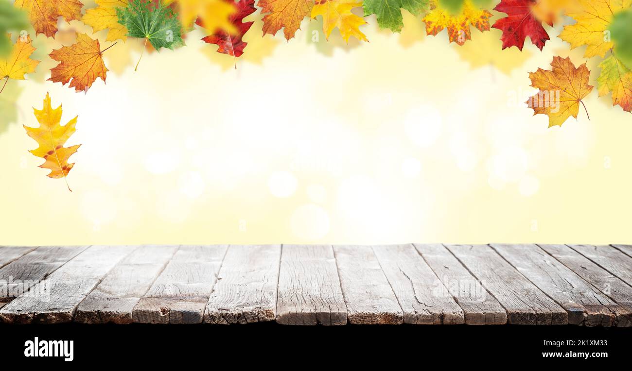 Wooden table and autumn bokeh background for your product Stock Photo