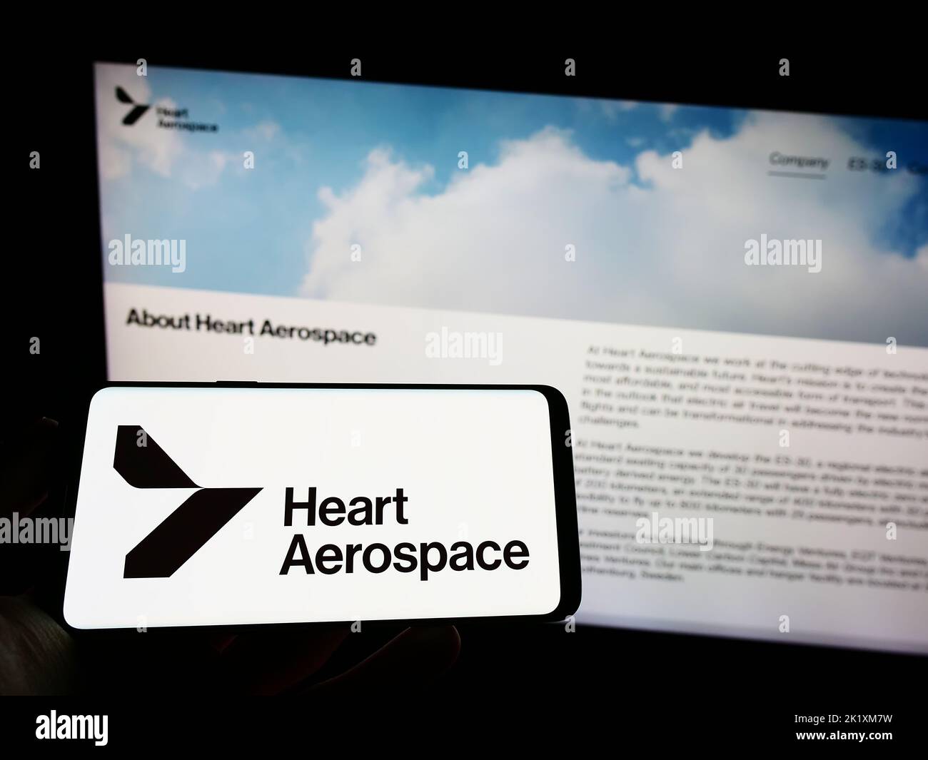 Person holding mobile phone with logo of Swedish company Heart Aerospace AB on screen in front of business web page. Focus on phone display. Stock Photo