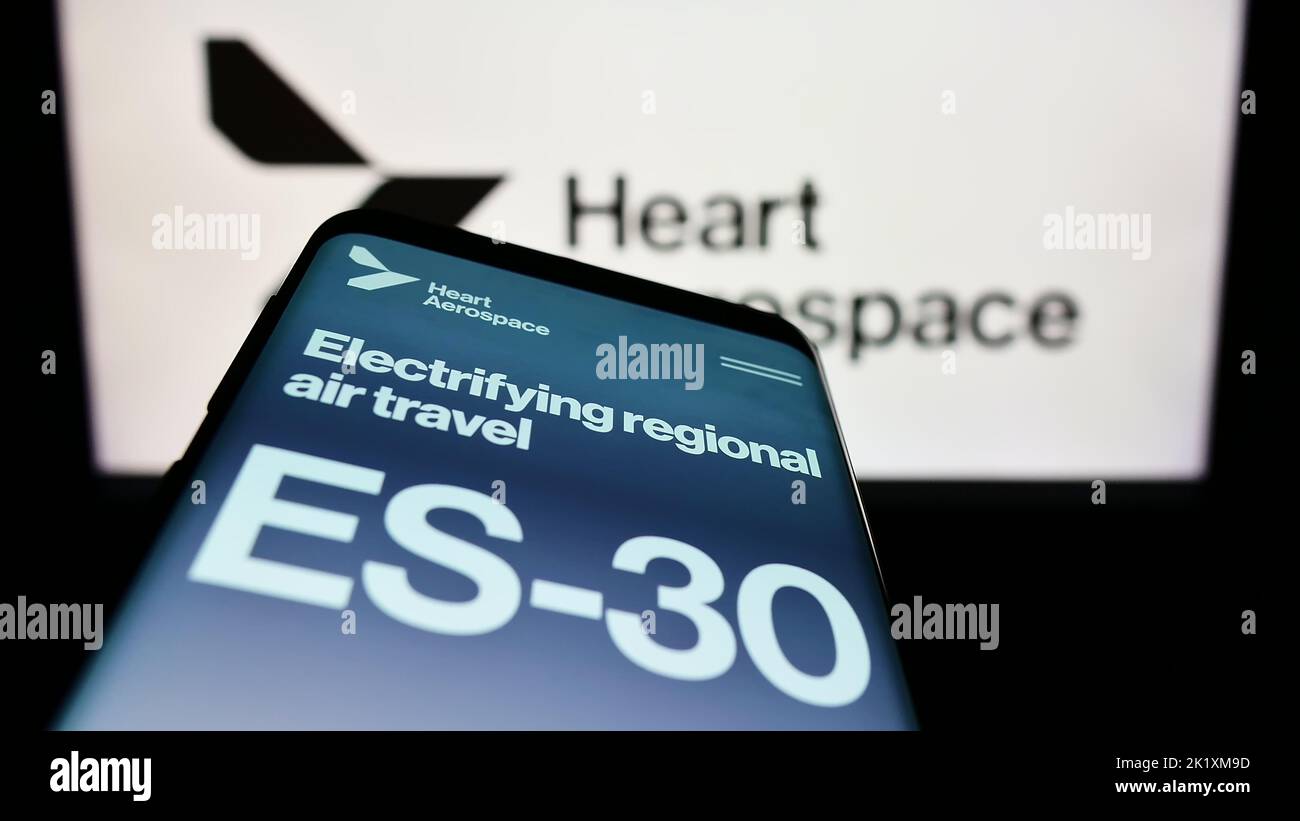 Mobile phone with website of Swedish company Heart Aerospace AB on screen in front of business logo. Focus on top-left of phone display. Stock Photo