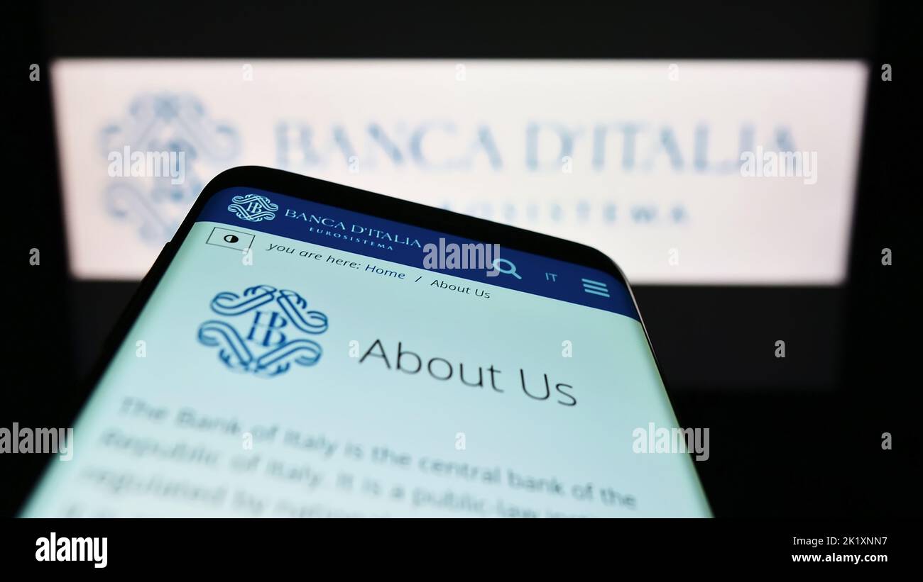 Smartphone with website of Italian central bank Banca d'Italia on screen in front of logo. Focus on top-left of phone display. Stock Photo