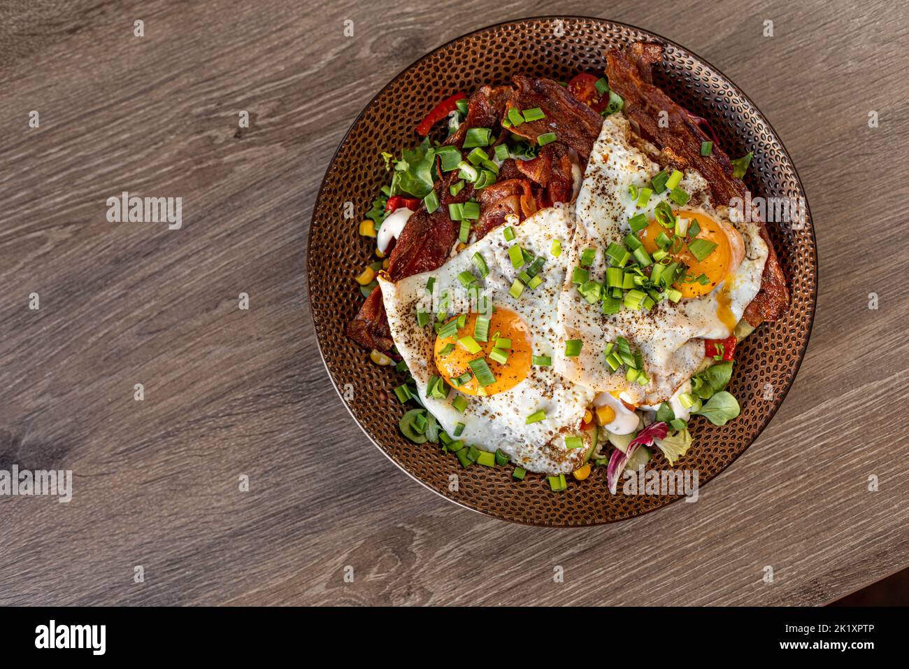 Tasty, yummy fried egg, scrambled egg, with meat, chicken on plate in