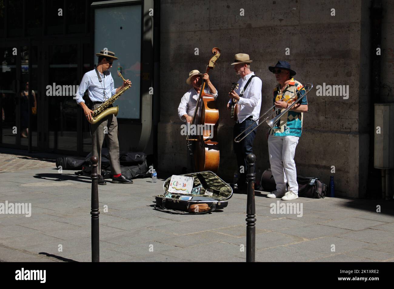 Four man band busking on a Parisian street in summer Stock Photo Alamy
