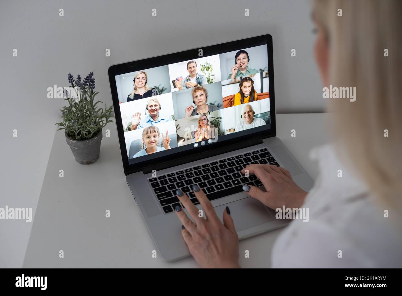 Caucasian female teacher using computer and laptop on video call with ...