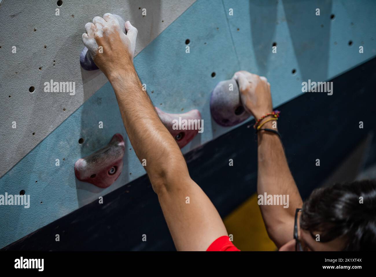 Hand reaching a climbing hold on a climbing wall Stock Photo Alamy