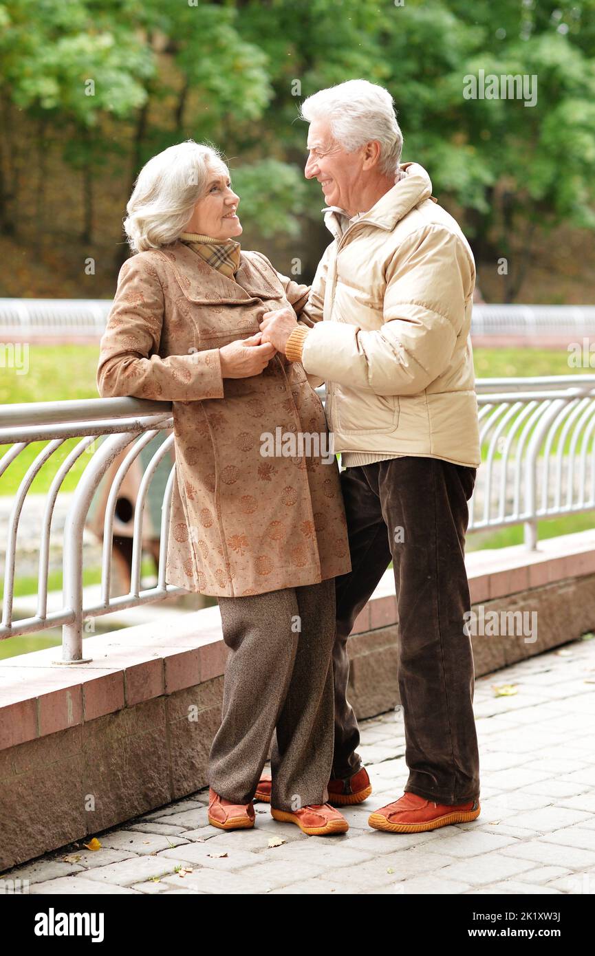 Elderly couple in the park in autumn. In full growth Stock Photo