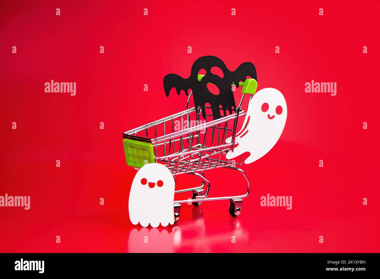 Three black and white papercut ghosts are flying and standing next to