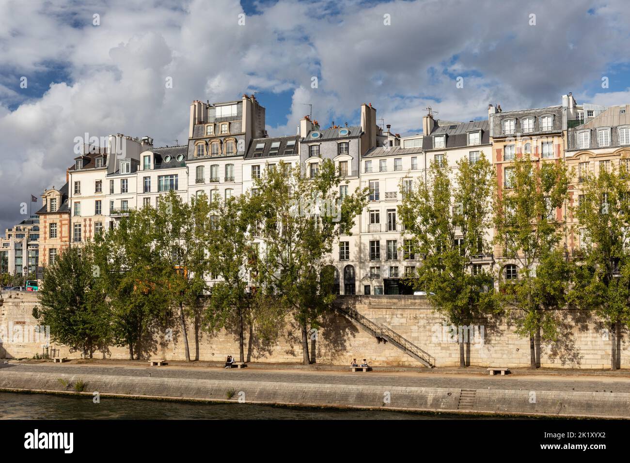 Sunlit row of Parisian houses situated beside the River Seine in Paris, Wonderful French architecture, France, Europe Stock Photo