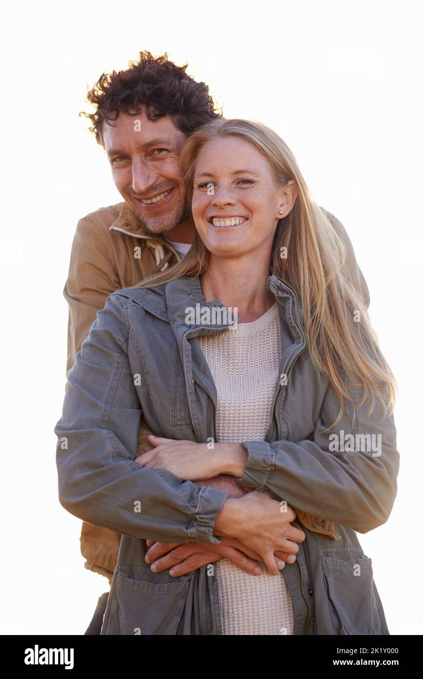 It must be love. A cropped portrait of a happy man and his wife standing affectionately outdoors. Stock Photo