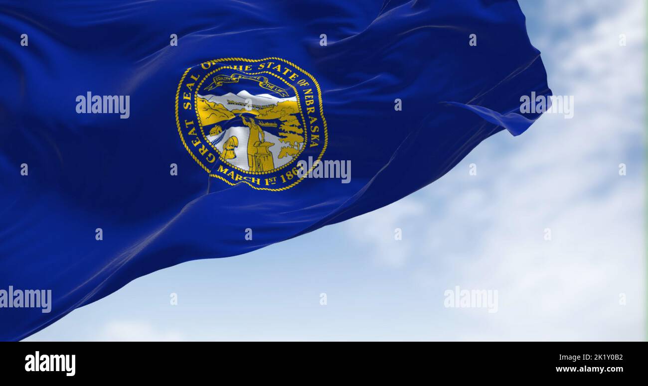 The Nebraska state flag waving in the wind. Nebraska is a state in the Midwestern region of the United States. Stock Photo