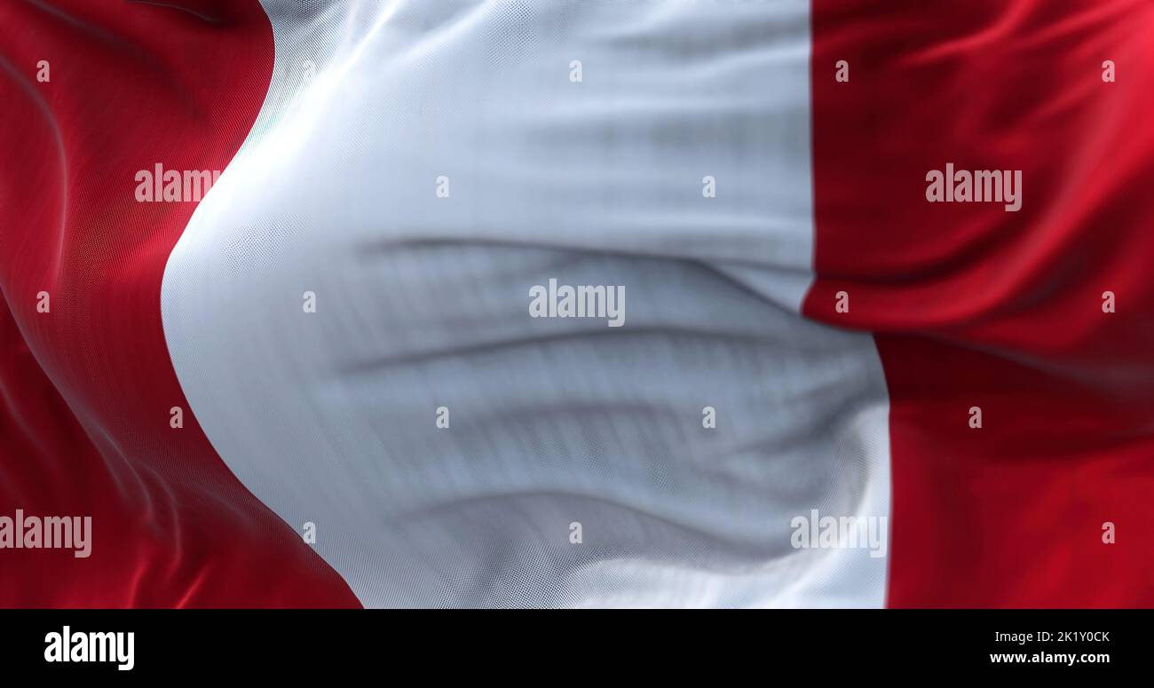 Close-up view of the Peru national flag waving in the wind. Republic of Peru is a country in western South America. Fabric textured background. Select Stock Photo