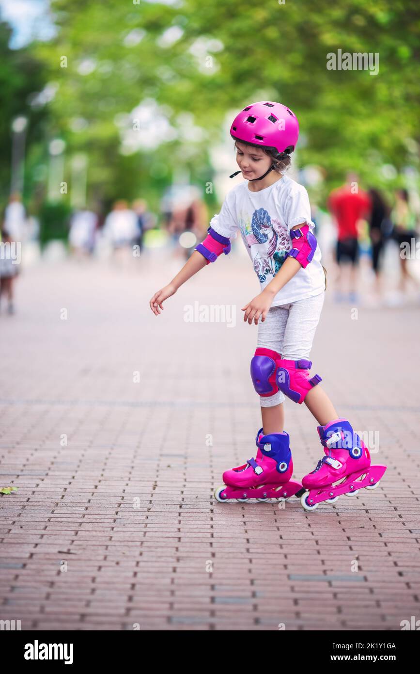 Little girl riding roller skates.  Woman on roller blades. Varna, Bulgaria Stock Photo