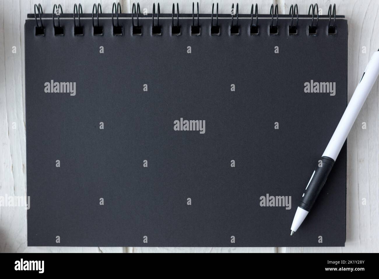 Note book with black pages with a pen Stock Photo Alamy