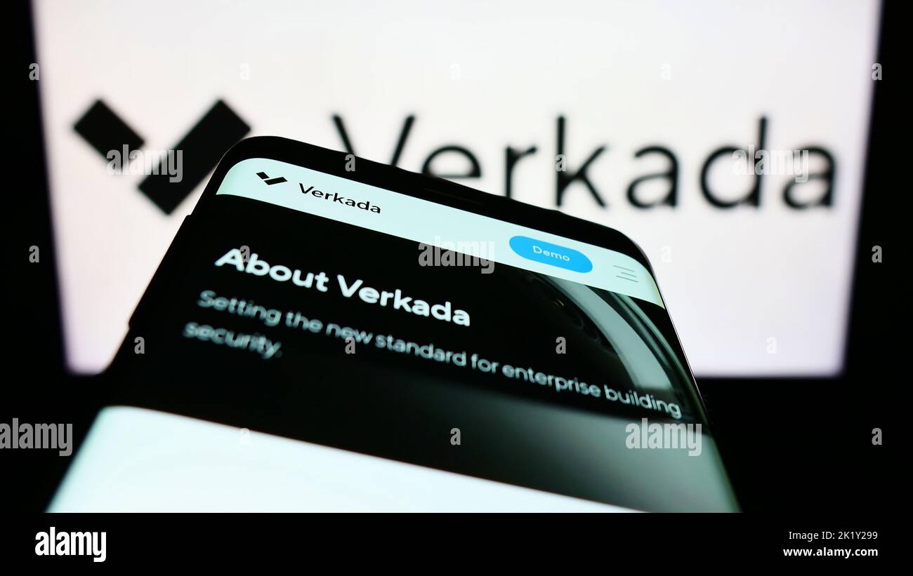 Mobile phone with webpage of American security systems company Verkada Inc. on screen in front of logo. Focus on top-left of phone display. Stock Photo