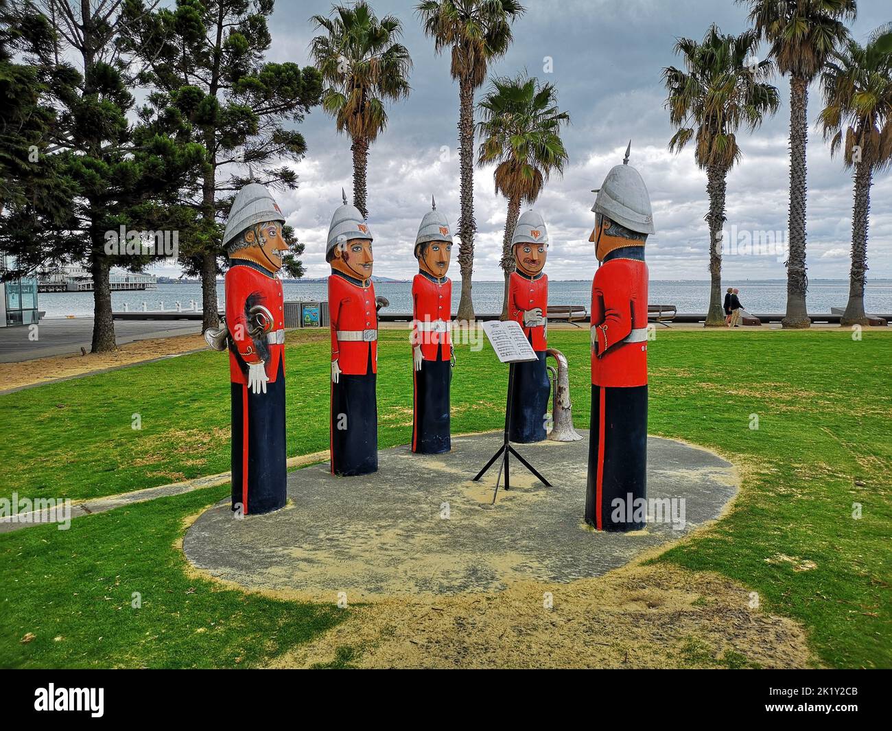 The statues of the Baywalk Bollards in the park in Geelong, Australia with palm trees and