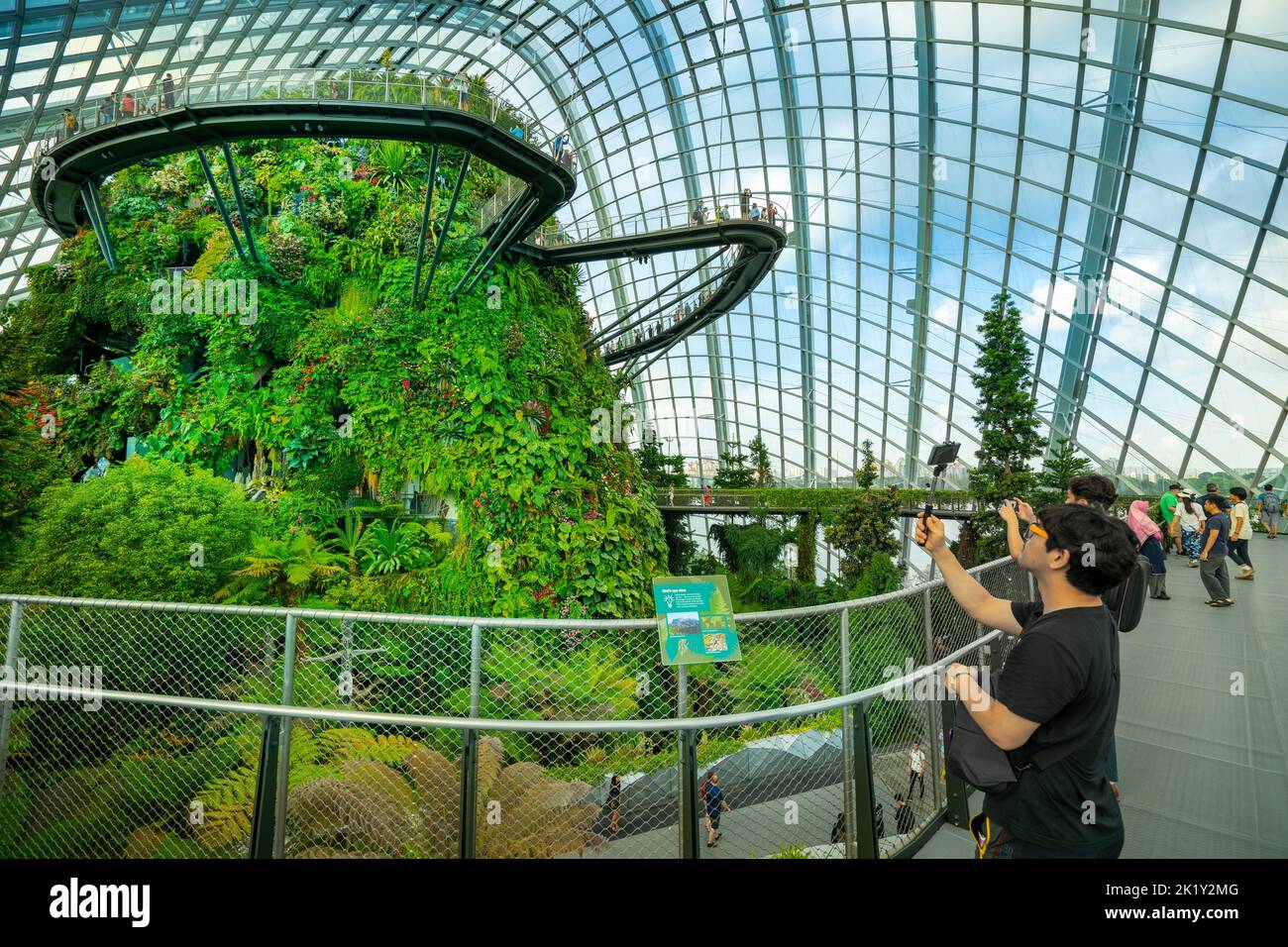 Visitors taking photo of the 42-metre Cloud Mountain in the Cloud Forest, in the Gardens by the Bay, Marina Bay Singapore Stock Photo