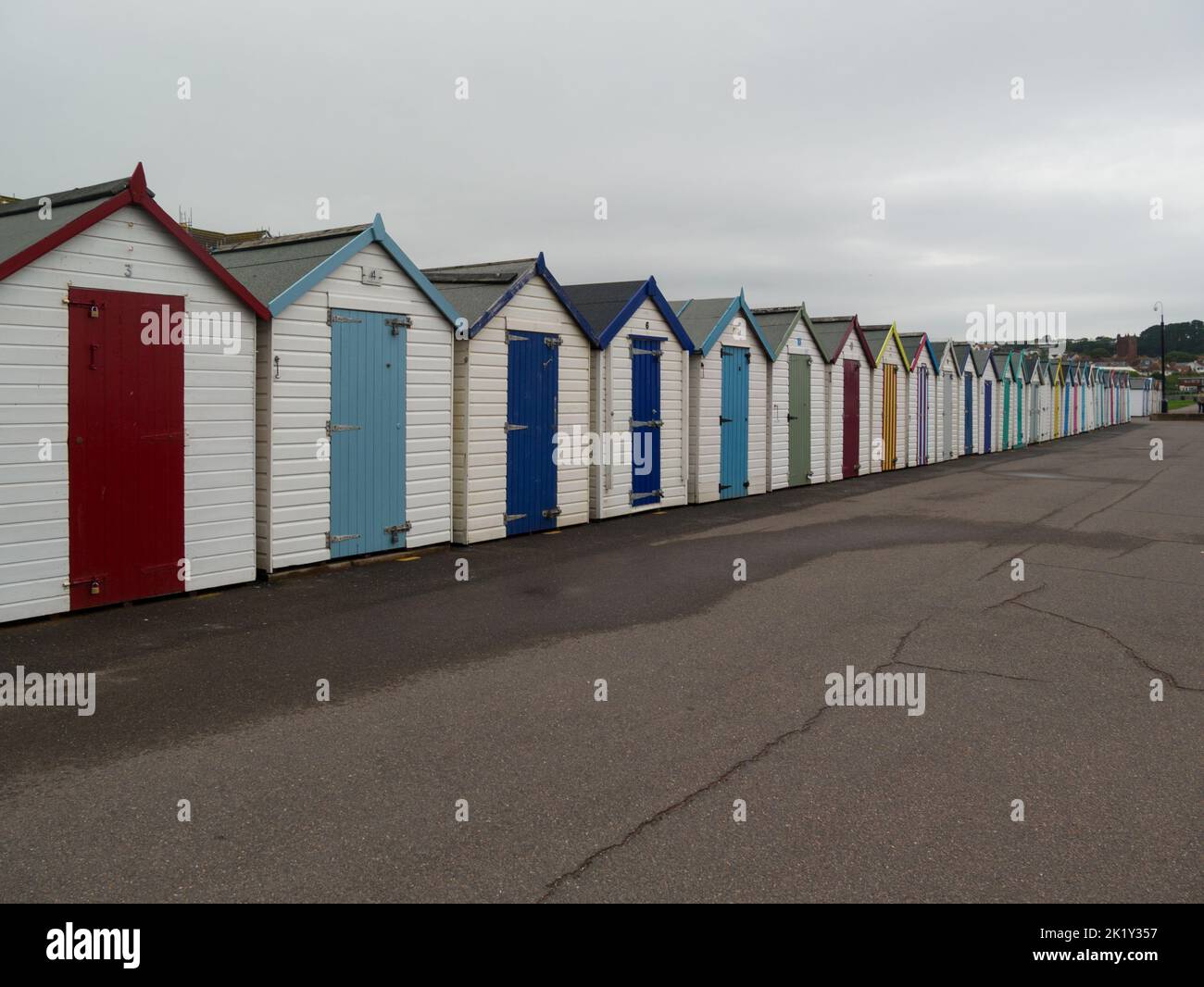 Row of colourful beach huts along Paignton seafront Devon England UK in this popular south coast seaside resort on English Riviera, Stock Photo