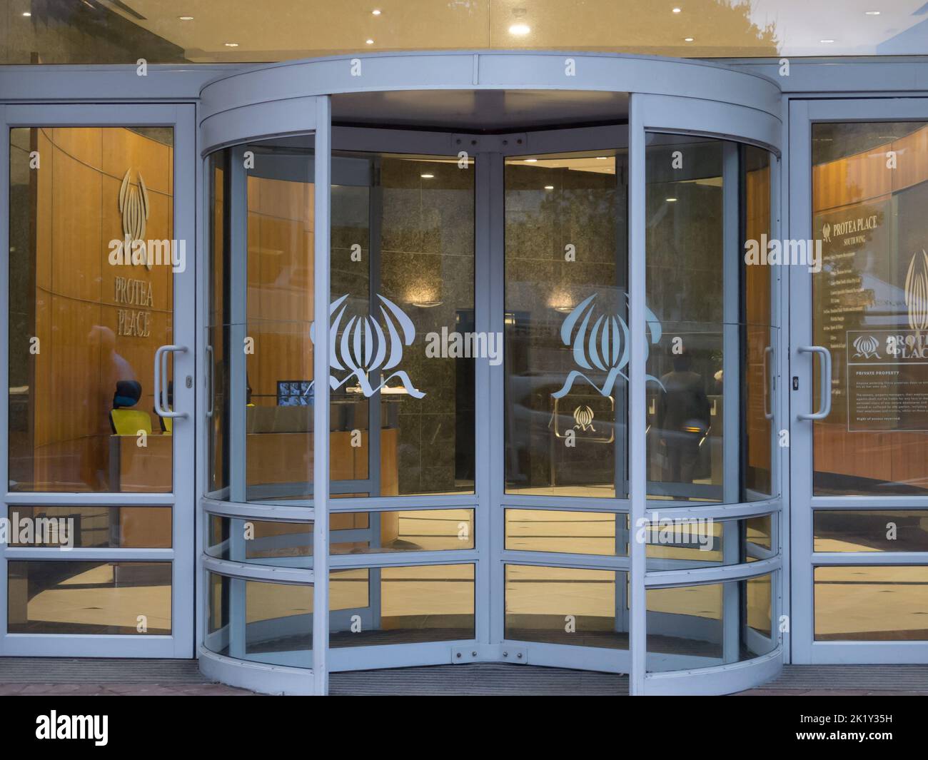 revolving door made of glass and steel closeup at an office block entrance Stock Photo