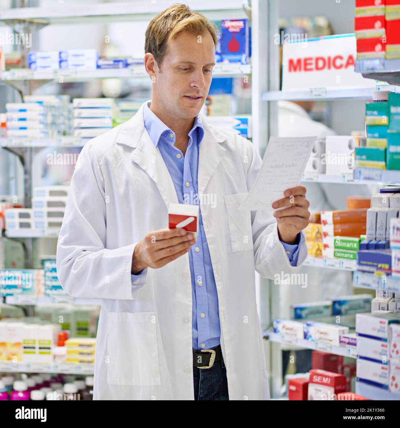 Ready to dispense your prescription. A pharmacist reading a prescription. Stock Photo