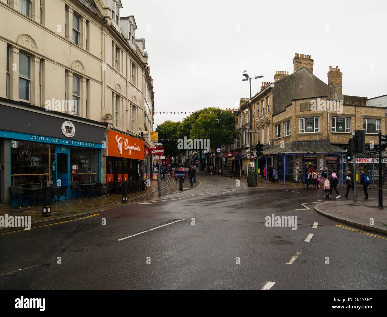 View along pedestrianised main shopping street Paignton Devon England UK on a grey wet day Stock Photo