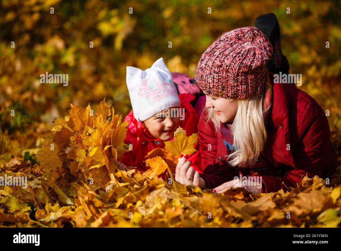 Young mother with her little daughter in an autumn park Stock Photo - Alamy