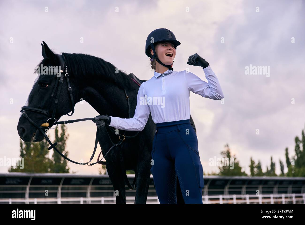 Winner. Young sportive girl, professional jockey or horsewoman in