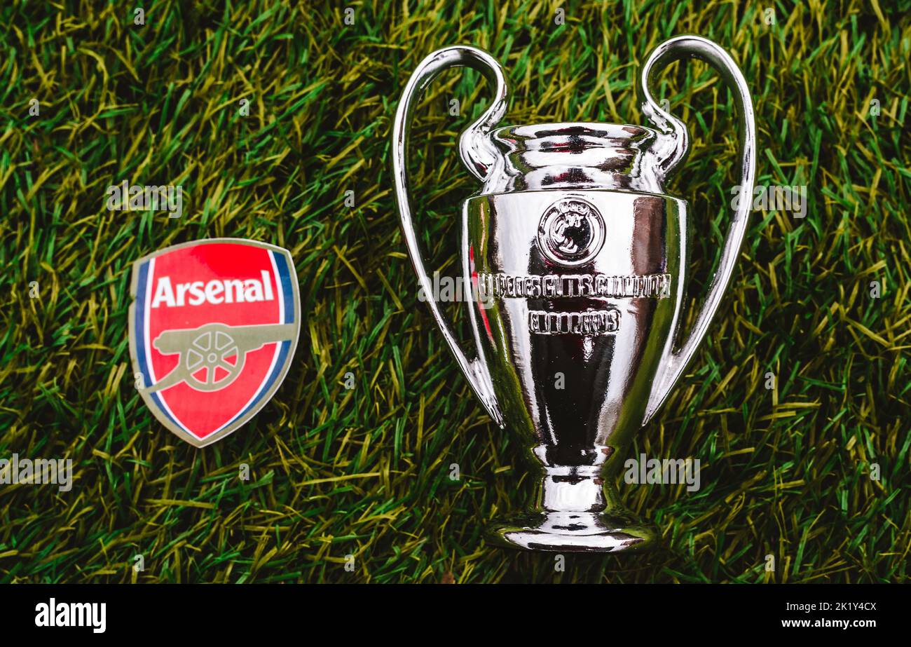 April 21, 2021, Moscow, Russia. The emblem of the football club Arsenal F.C. London and the UEFA Champions League Cup on the green grass of the stadiu Stock Photo