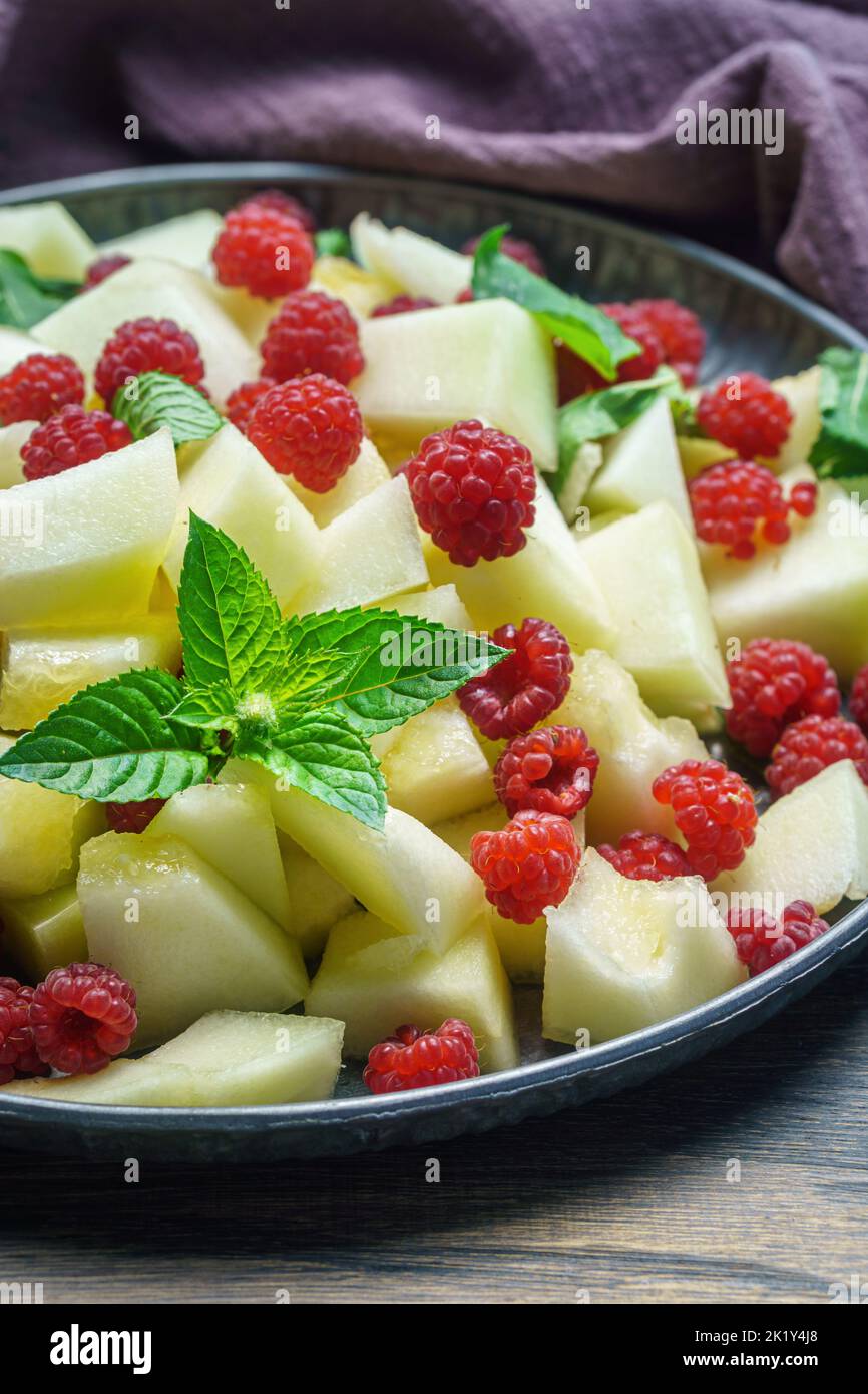 Melon raspberry summer salad with mint closeup Stock Photo