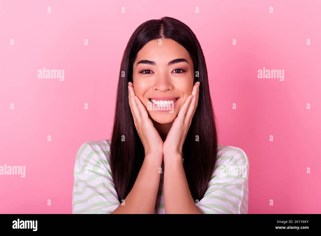 Portrait of positive lady touching hands face showing her bright ...