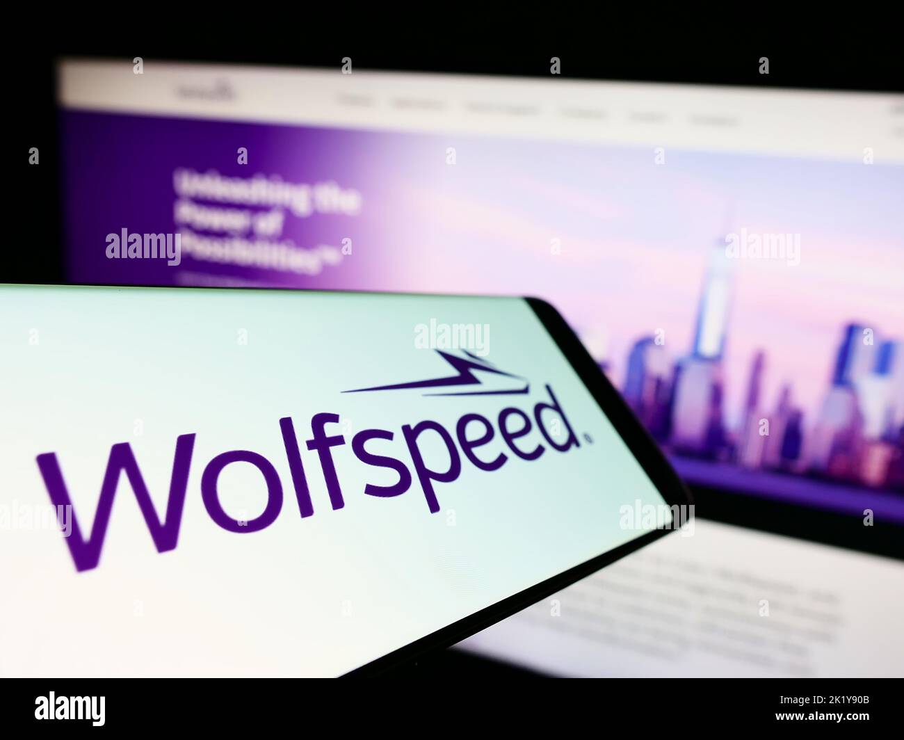 Mobile phone with logo of American semiconductor company Wolfspeed Inc. on screen in front of business website. Focus on center of phone display. Stock Photo